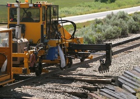 The first step I observed was a "tie exchanger" lifting the rail up and sliding the old ties out to the side of the tracks.  I apparently missed the part of the process where the spikes were removed.  CRW 2583a